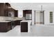 Spacious kitchen featuring stainless steel appliances, dark wood cabinets, a kitchen island and tile floors at 2097 Celebration Blvd, Celebration, FL 34747