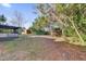 View of the backyard with trees, shed and lawn at 2102 Kingswood Ave, Deltona, FL 32725