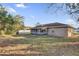 Large backyard with mature trees and a screened porch at 2102 Kingswood Ave, Deltona, FL 32725