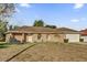 Brick house with a two-car garage and a spacious lawn at 2102 Kingswood Ave, Deltona, FL 32725