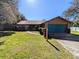 Ranch style home with teal garage door and brick facade at 3021 Norvell Ct, Deltona, FL 32738