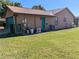 Rear exterior showing garage, AC unit, and grassy yard at 3021 Norvell Ct, Deltona, FL 32738