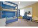 Nicely appointed bedroom with custom blue bunk beds and built-in desk at 3359 Hanging Tide St, Winter Garden, FL 34787