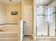 Bright bathroom featuring a soaking tub and glass-enclosed shower at 5303 Wildwood Way, Davenport, FL 33837
