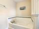 A close-up of the soaking tub with decorative tile surround at 5303 Wildwood Way, Davenport, FL 33837