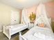 Charming bedroom with canopied twin beds and a castle decoration at 5303 Wildwood Way, Davenport, FL 33837
