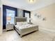 Comfortable bedroom showcasing king bed, tasteful furnishings, and natural lighting at 5303 Wildwood Way, Davenport, FL 33837