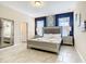 Beautiful primary bedroom featuring a king bed, ensuite bath, and stylish decor at 5303 Wildwood Way, Davenport, FL 33837