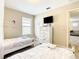 Bedroom with twin beds, TV, and light-colored walls at 5303 Wildwood Way, Davenport, FL 33837