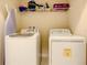 Functional laundry room equipped with modern appliances and storage space at 5303 Wildwood Way, Davenport, FL 33837