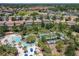 Aerial view of a lazy river with lush landscaping and umbrellas in a community of single-Gathering homes at 5303 Wildwood Way, Davenport, FL 33837