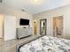 Primary bedroom with tile flooring, TV, dresser, and ensuite bathroom at 5303 Wildwood Way, Davenport, FL 33837