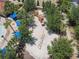 Aerial view of a playground with a sandbox, climbing structures, and shade trees in a community park at 5303 Wildwood Way, Davenport, FL 33837