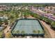 Aerial view of two tennis courts, palm trees, and landscaping, in a community of single-Gathering homes at 5303 Wildwood Way, Davenport, FL 33837