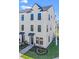 Beautiful three-story townhome with modern design, sleek black windows, and charming walkway leading to the front door at 15142 Grove Lake Dr, Winter Garden, FL 34787