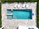 Aerial view of a luxurious private pool with lounge chairs and well-maintained landscaping at 159 Golden Noble St, Kissimmee, FL 34747