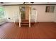 Back porch features stairs and white railings with a view of the backyard at 306 Wild Olive Ln, Longwood, FL 32779