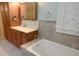 Bathroom featuring vanity, large linen closet, and a soaking tub with tile surround at 306 Wild Olive Ln, Longwood, FL 32779