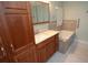 Bathroom featuring vanity, large linen closet, and a soaking tub with tile surround at 306 Wild Olive Ln, Longwood, FL 32779