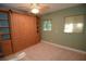 A well-lit bedroom featuring a wall bed and storage with ample built-in shelving at 306 Wild Olive Ln, Longwood, FL 32779