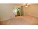 A bedroom with neutral walls, fan, and access to the screened lanai at 306 Wild Olive Ln, Longwood, FL 32779