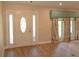 Bright entryway with a decorative door and light wood flooring at 306 Wild Olive Ln, Longwood, FL 32779