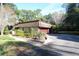 Stone facade home featuring a well-maintained yard and driveway at 306 Wild Olive Ln, Longwood, FL 32779