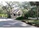 Charming guard house with stone accents, tile roof, and meticulously landscaped surroundings at 306 Wild Olive Ln, Longwood, FL 32779