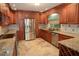 Updated kitchen with stainless steel appliances and granite countertops at 306 Wild Olive Ln, Longwood, FL 32779