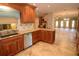 Well-appointed kitchen with wood cabinets, granite counters, and a view into the open-plan living space at 306 Wild Olive Ln, Longwood, FL 32779