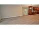 Living room leading to the kitchen with tile floors and natural light at 306 Wild Olive Ln, Longwood, FL 32779