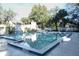Community pool with lifeguard house, plenty of seating, and mature shade trees at 306 Wild Olive Ln, Longwood, FL 32779