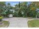This backyard features an extra shed, a patio and beautiful landscaping at 1098 Park Dr, Casselberry, FL 32707