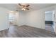 This bedroom features laminate flooring, a ceiling fan, and a closet at 1098 Park Dr, Casselberry, FL 32707