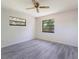 This bedroom features new laminate flooring, two windows, and white walls at 1098 Park Dr, Casselberry, FL 32707