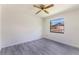 This bedroom features new laminate flooring, one window, and white walls at 1098 Park Dr, Casselberry, FL 32707