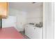 Bright laundry room with modern washer and dryer and white cabinets at 1098 Park Dr, Casselberry, FL 32707