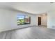 Bright living room with large window and modern wood-look flooring at 1098 Park Dr, Casselberry, FL 32707