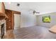 Bright living room with stone fireplace and gray wood-look flooring at 1098 Park Dr, Casselberry, FL 32707