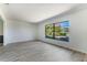 Bright living room featuring gray wood flooring, a large window, and white walls at 1098 Park Dr, Casselberry, FL 32707