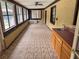 The sunroom features windows, a ceiling fan, and tile flooring at 1098 Park Dr, Casselberry, FL 32707