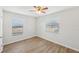 Well-lit bedroom with two windows and wood-look floors at 1748 Haverhill Dr, Deltona, FL 32725