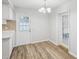 Bright dining area with wood-look floors and sliding glass door at 1748 Haverhill Dr, Deltona, FL 32725
