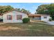 Ranch style home with brown shutters and a well-manicured lawn at 1748 Haverhill Dr, Deltona, FL 32725