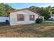 Side view of the house showcasing its light beige siding at 1748 Haverhill Dr, Deltona, FL 32725