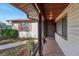 Covered porch entryway with tiled flooring and brown door at 1748 Haverhill Dr, Deltona, FL 32725