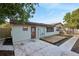 Rear view of house with wooden deck and attached shed at 1748 Haverhill Dr, Deltona, FL 32725