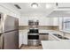 Modern kitchen with stainless steel appliances and white cabinets at 1748 Haverhill Dr, Deltona, FL 32725