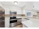 Modern kitchen with stainless steel appliances and white cabinets at 1748 Haverhill Dr, Deltona, FL 32725