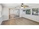 Sunroom with wood-look floors, ceiling fan and sliding glass doors at 1748 Haverhill Dr, Deltona, FL 32725
